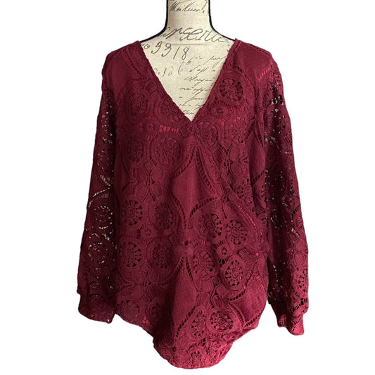 Red lace top on a mannequin with a white background