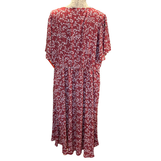 Red floral dress on a mannequin against a white background