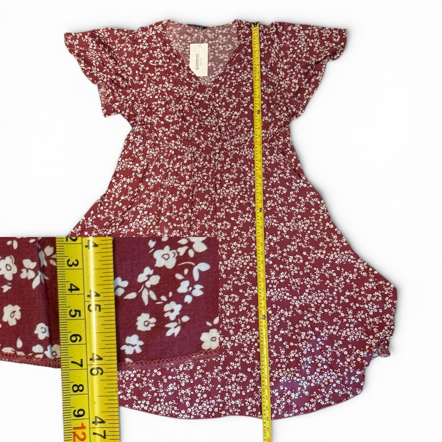 Floral dress with a measuring tape on a white background