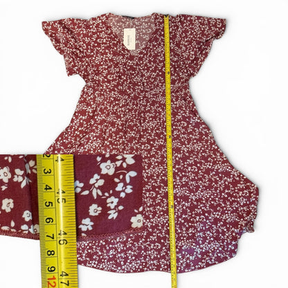Floral dress with a measuring tape on a white background