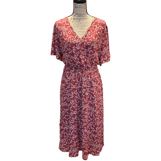 Red floral dress on a mannequin against a white background