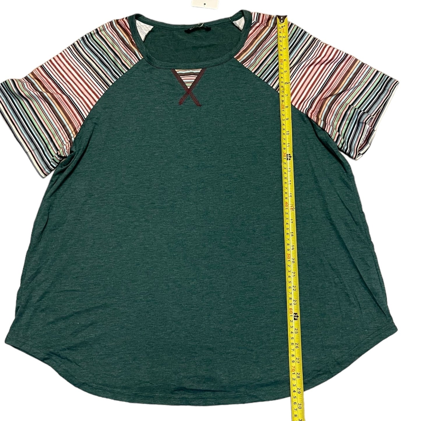 Green t-shirt with striped sleeves and a measuring tape on a white background
