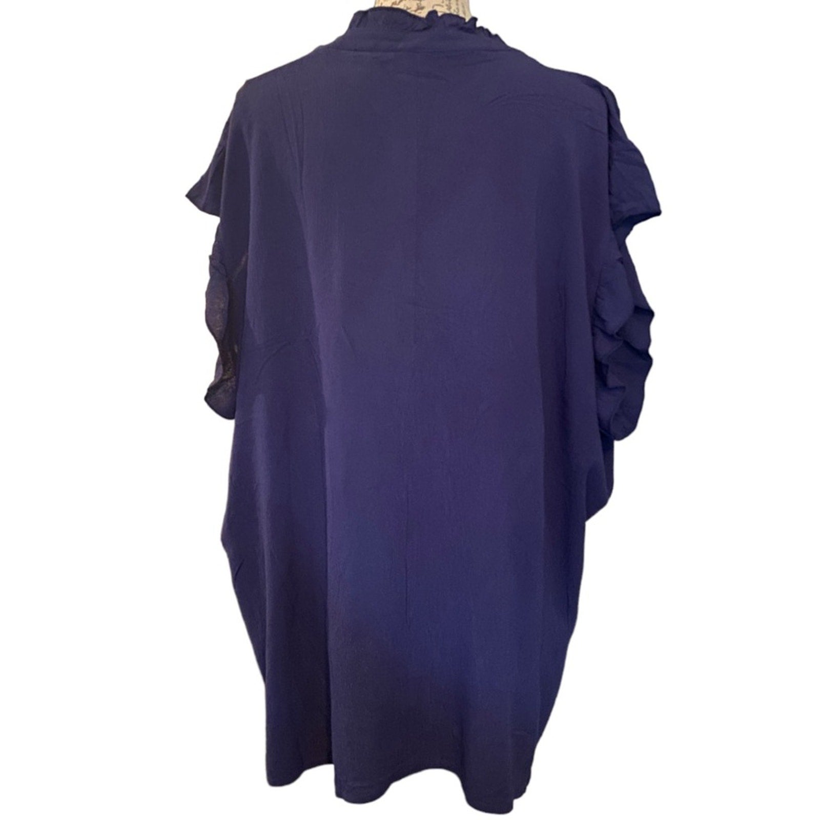 Navy blue shirt on a mannequin with a white background