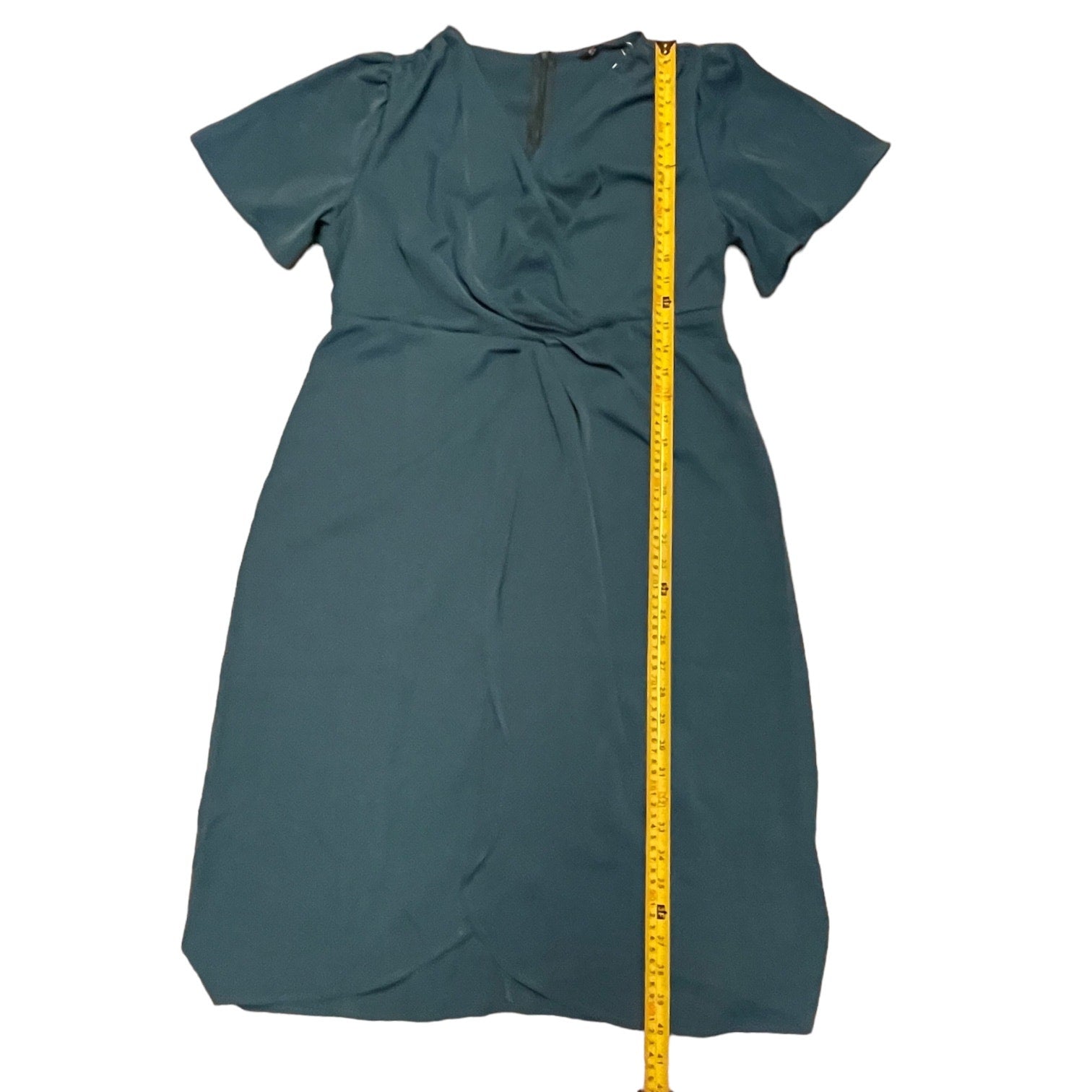 dress with a yellow measuring tape on a white background
