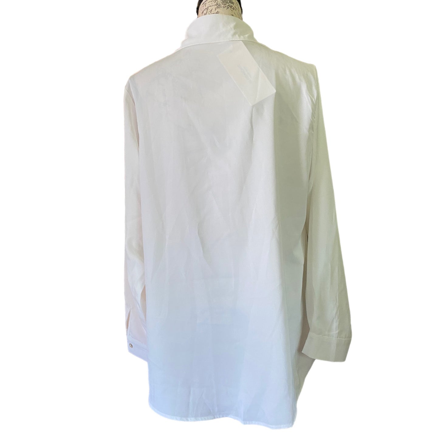 Back of White shirt on a mannequin against a white background