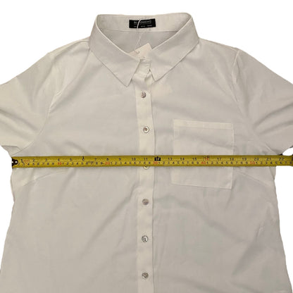 White shirt with a measuring tape laid across it on a white background