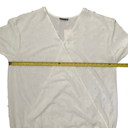 White blouse with a measuring tape across it on a white background