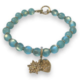Blue beaded bracelet with a silver charms on a white background