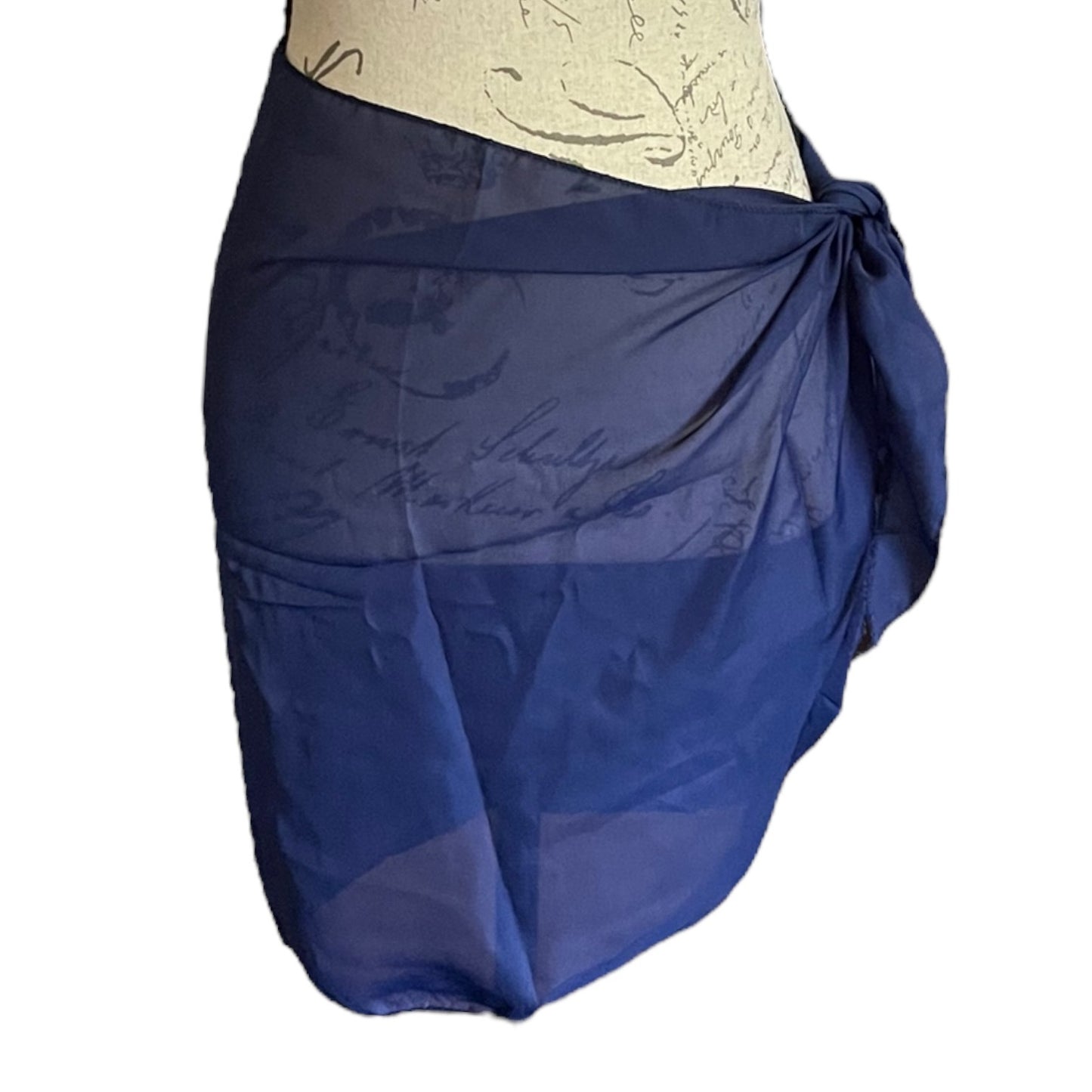 A blue sheer sarong wrap , shown wrapped around a beige mannequin torso against a white background.