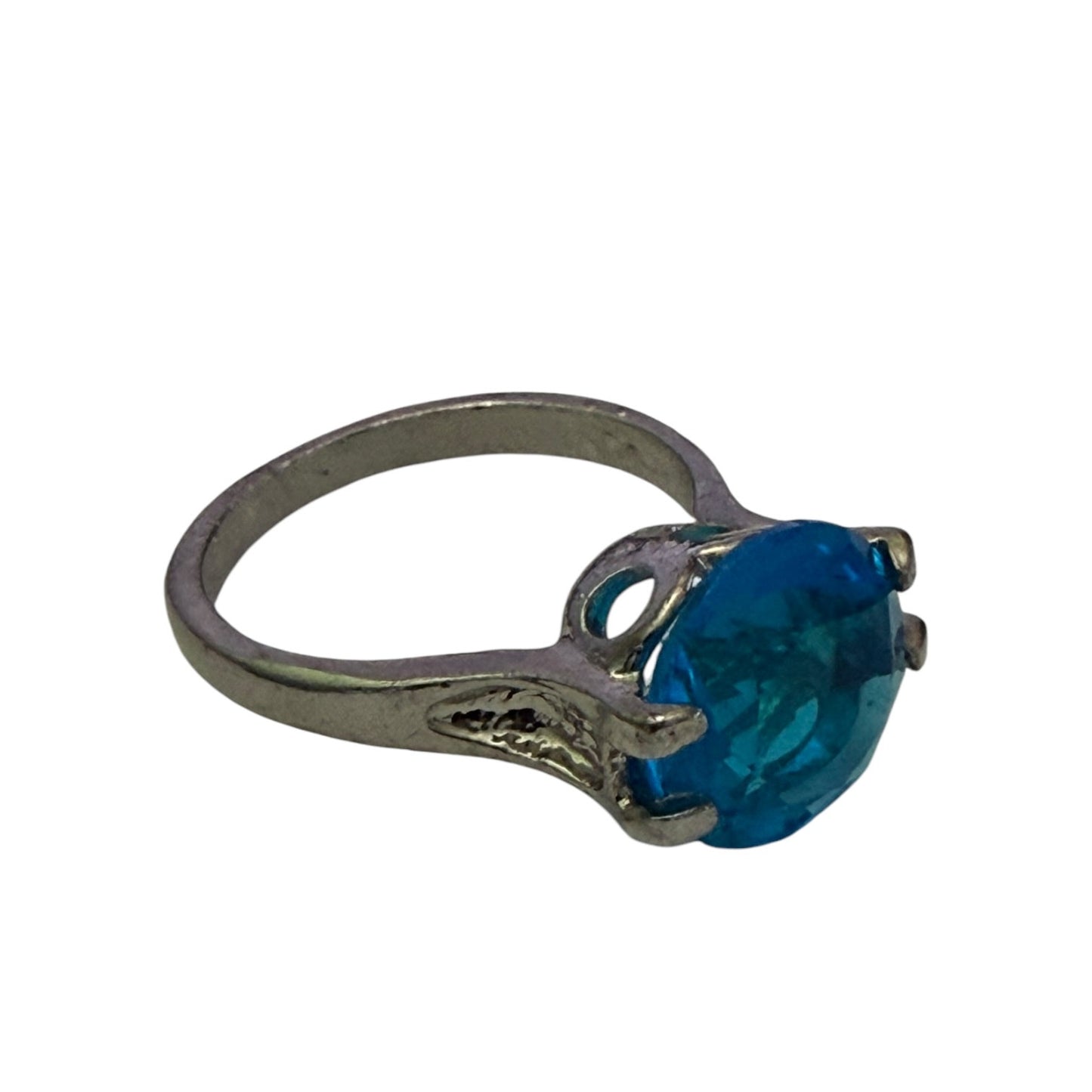 A silver-toned ring featuring a large, oval-cut blue stone in a prong setting, shown against a plain white background.