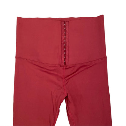 High-waisted leggings with a center front zipper and hook-and-eye closure, shown against a plain white background.