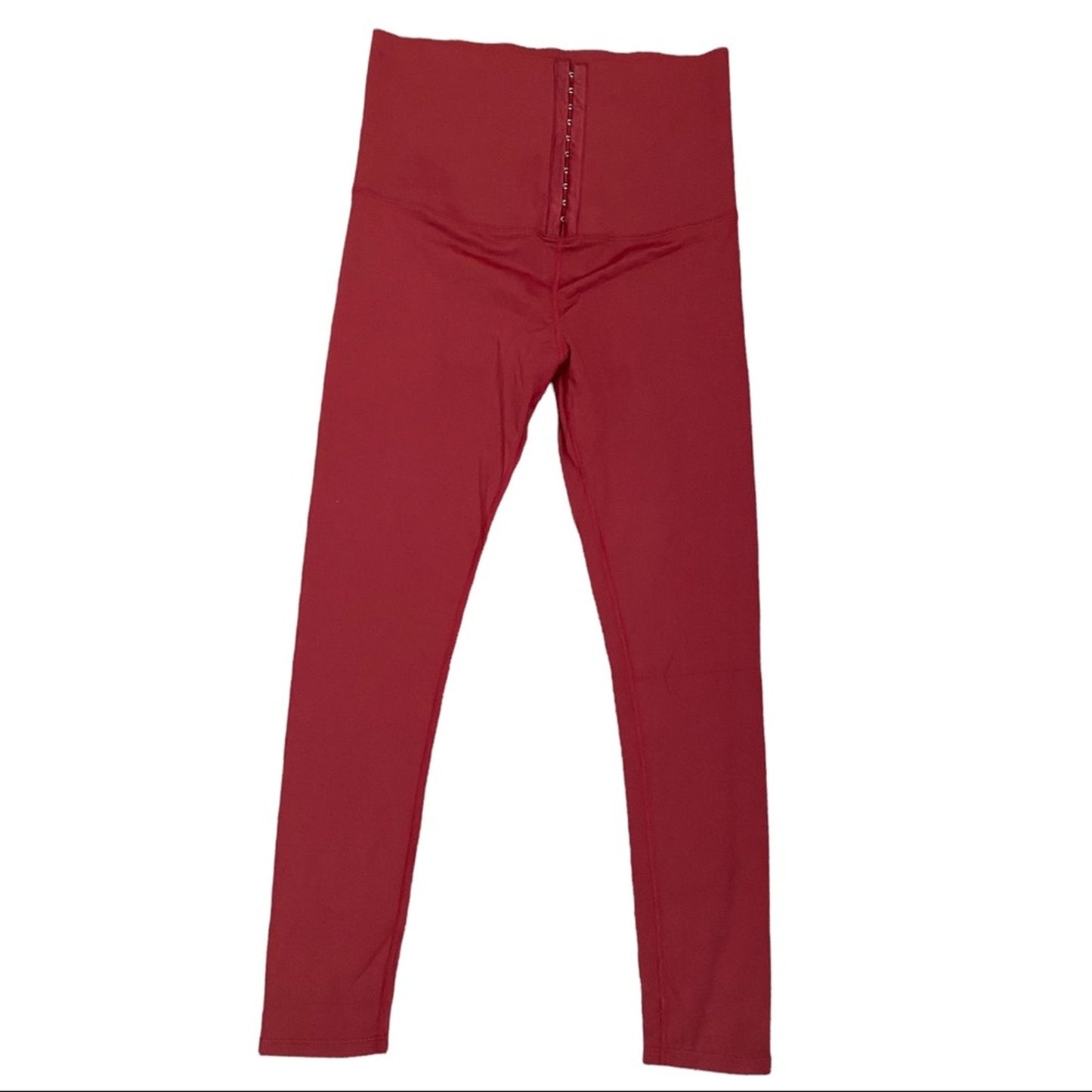 A pair of high-waisted burgundy leggings with a central seam and zipper detail at the waist, shown flat against a white background.