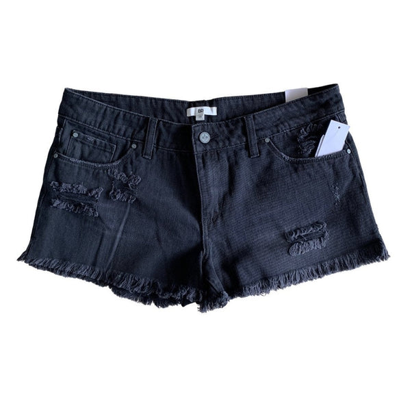 Front of Black denim shorts with frayed edges on a white background