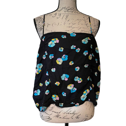 A black camisole-style top with a colorful floral print, displayed on a vintage-style dress form mannequin against a white background.