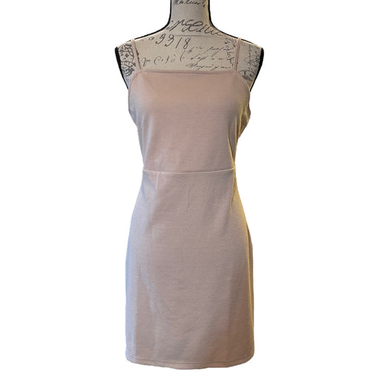 A sleeveless light beige colored mini dress displayed on a black dress form mannequin against a plain white background.