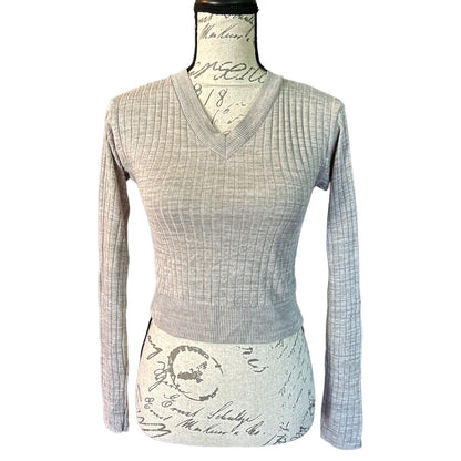A light gray ribbed knit long-sleeve V-neck sweater displayed on a dress form mannequin against a plain white background.