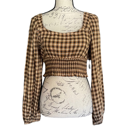 Plaid long-sleeve top on a mannequin with a white background
