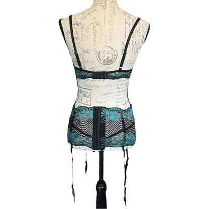 Back of black and green lace lingerie on a mannequin against a white background