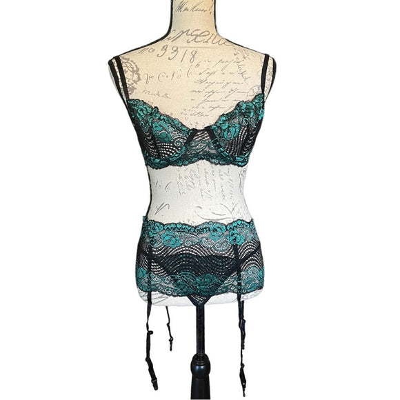 Black lace lingerie set on a mannequin with a white background