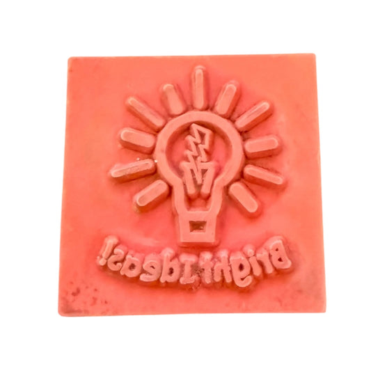 Red rubber stamp with a light bulb design and 'Blighty Stamps' text on a white background