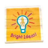 Wooden block with a light bulb icon and 'Bright Ideas!' text on a yellow background