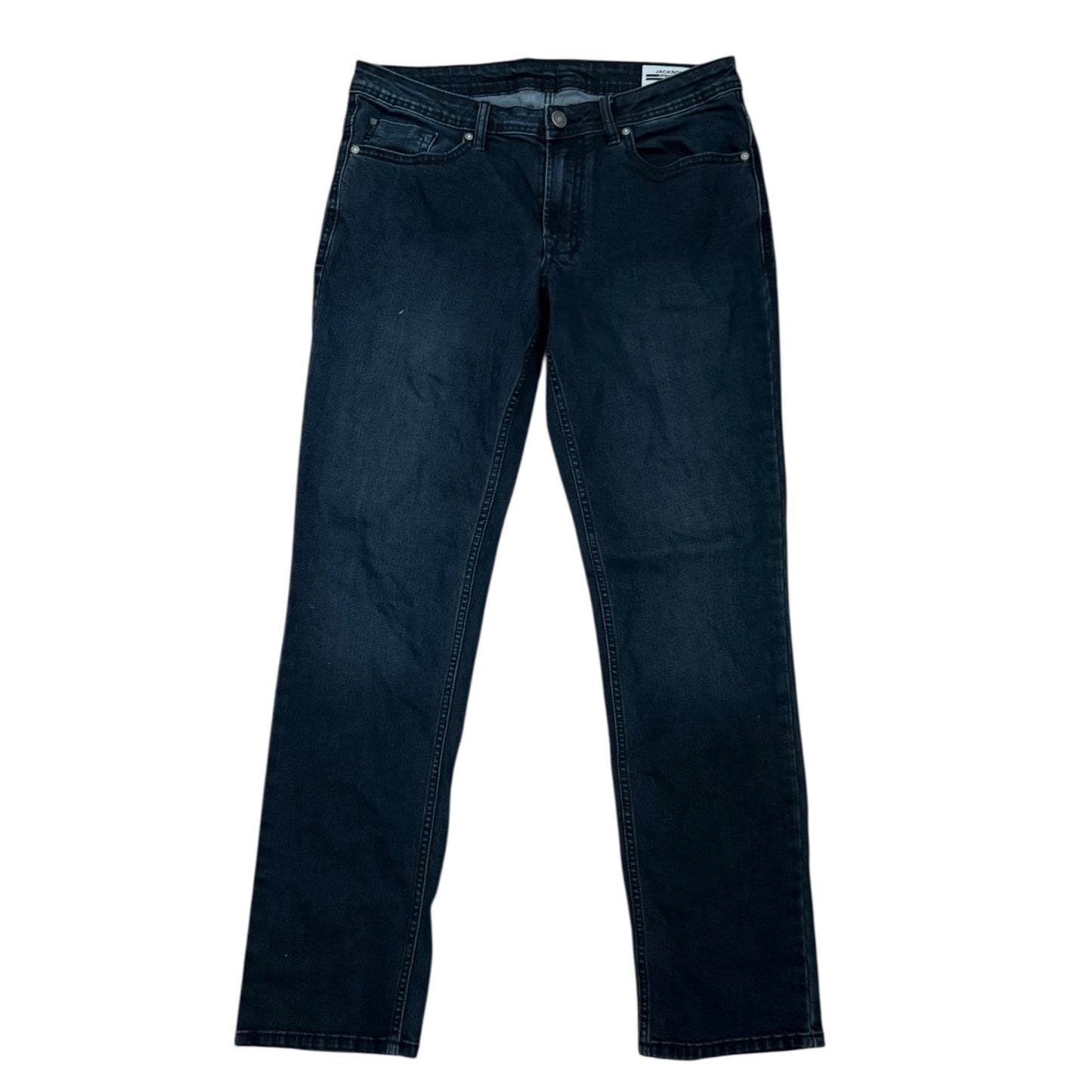 Front of Pair of dark blue jeans on a white background