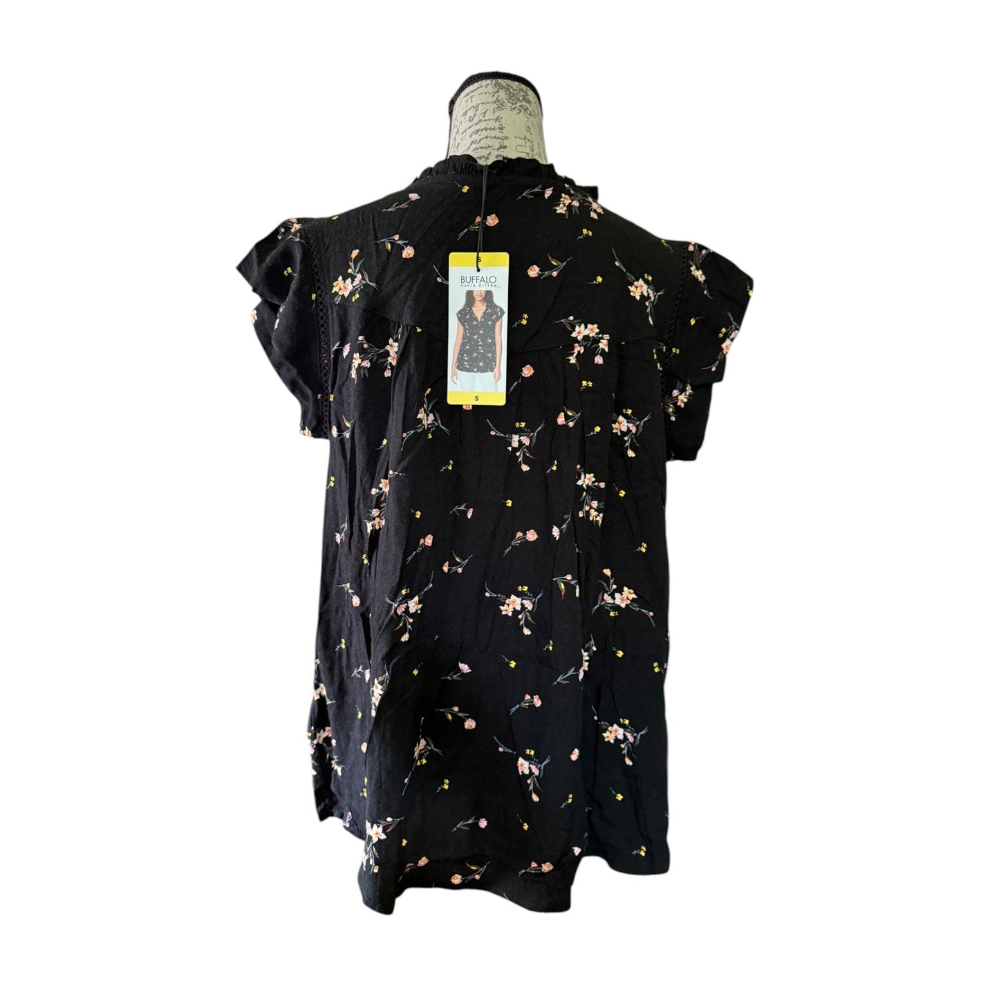 Black floral dress on a mannequin with a white background