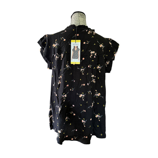 Black floral dress on a mannequin with a white background