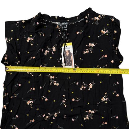 Black floral top with a measuring tape and tag on a white background
