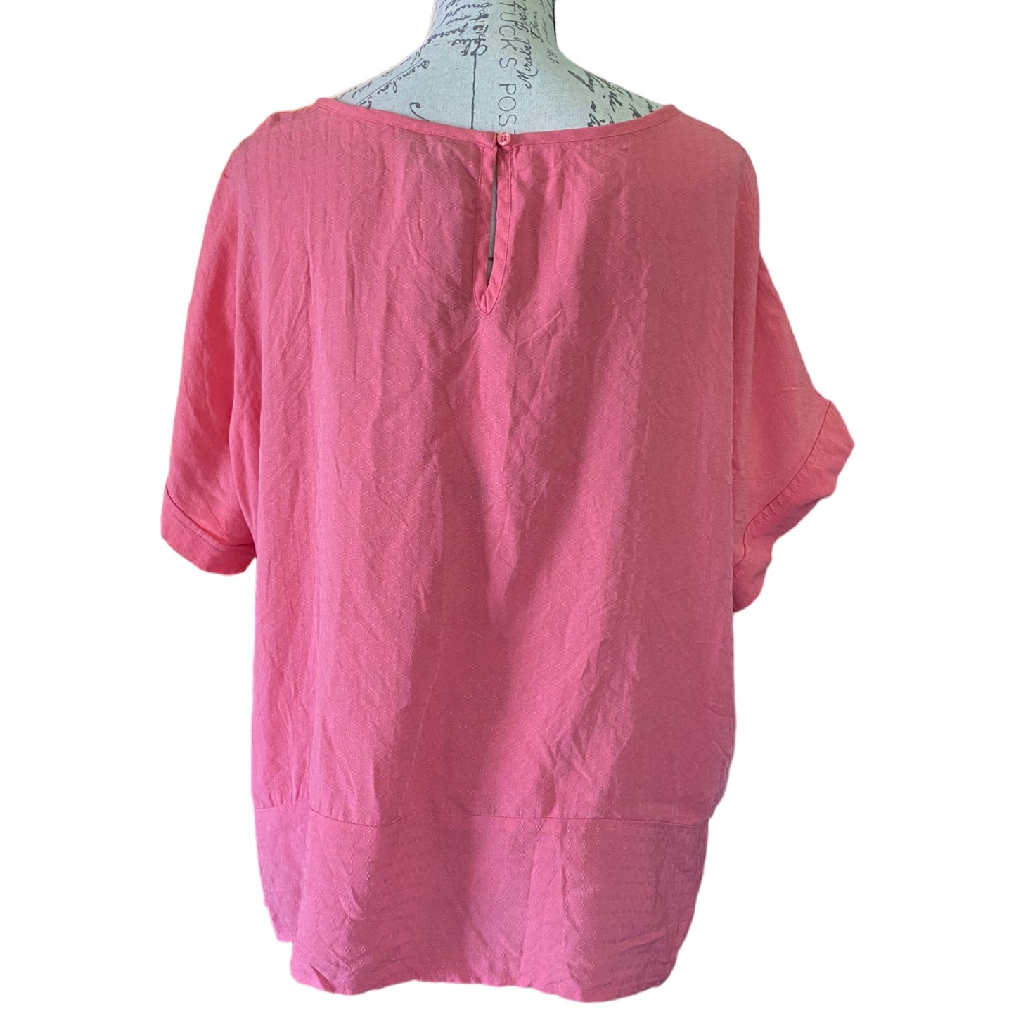Back of blouse on a mannequin with a white background