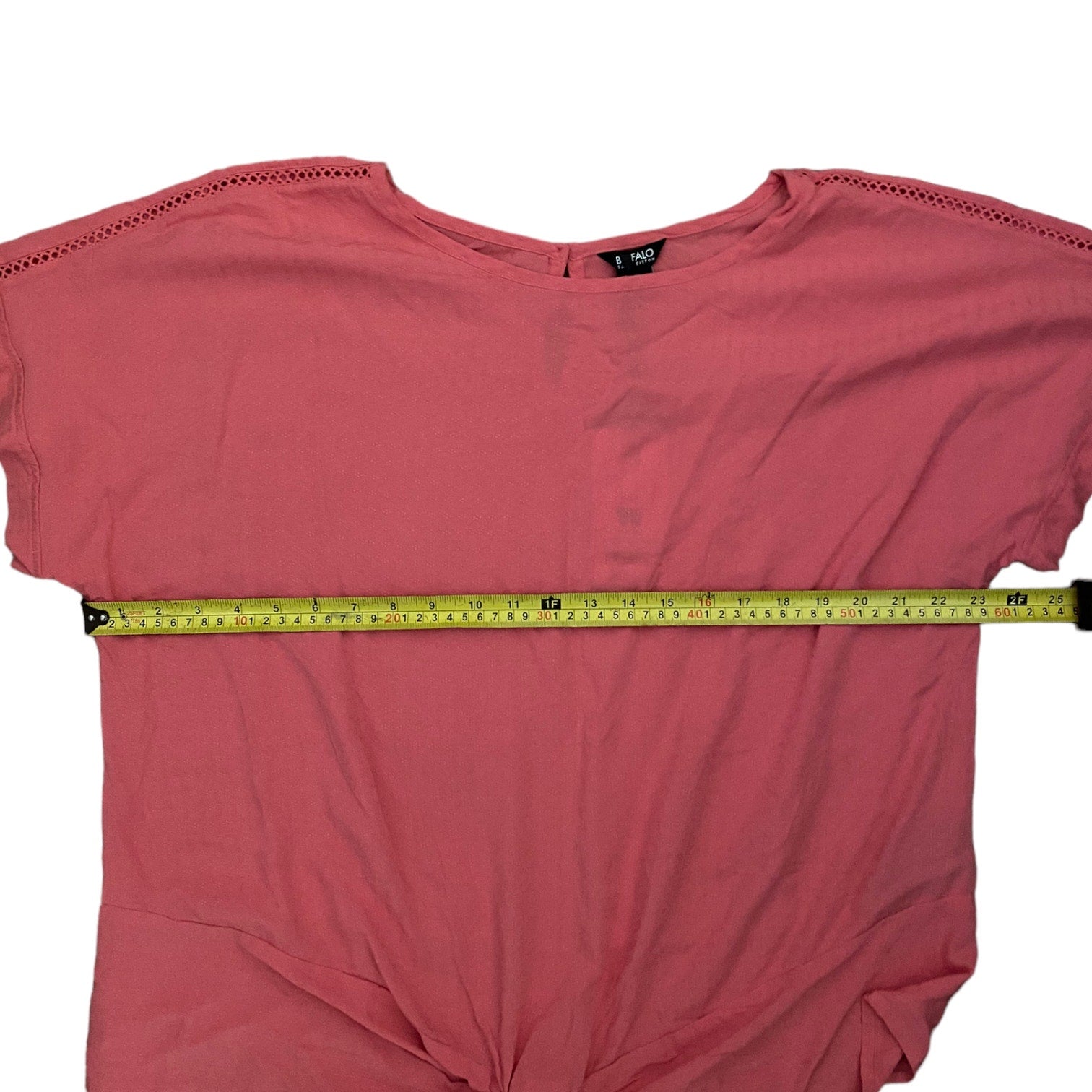 shirt with a measuring tape across it on a white background