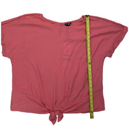 top with a measuring tape for size reference on a white background