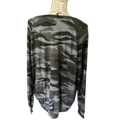 Back of Camouflage-patterned long-sleeve shirt on a mannequin against a white background