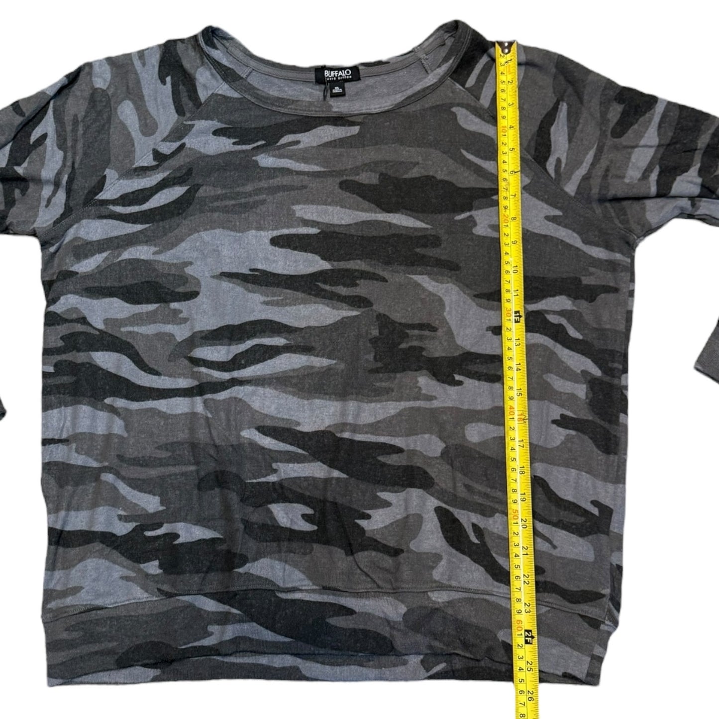 Camouflage t-shirt with a measuring tape on a white background