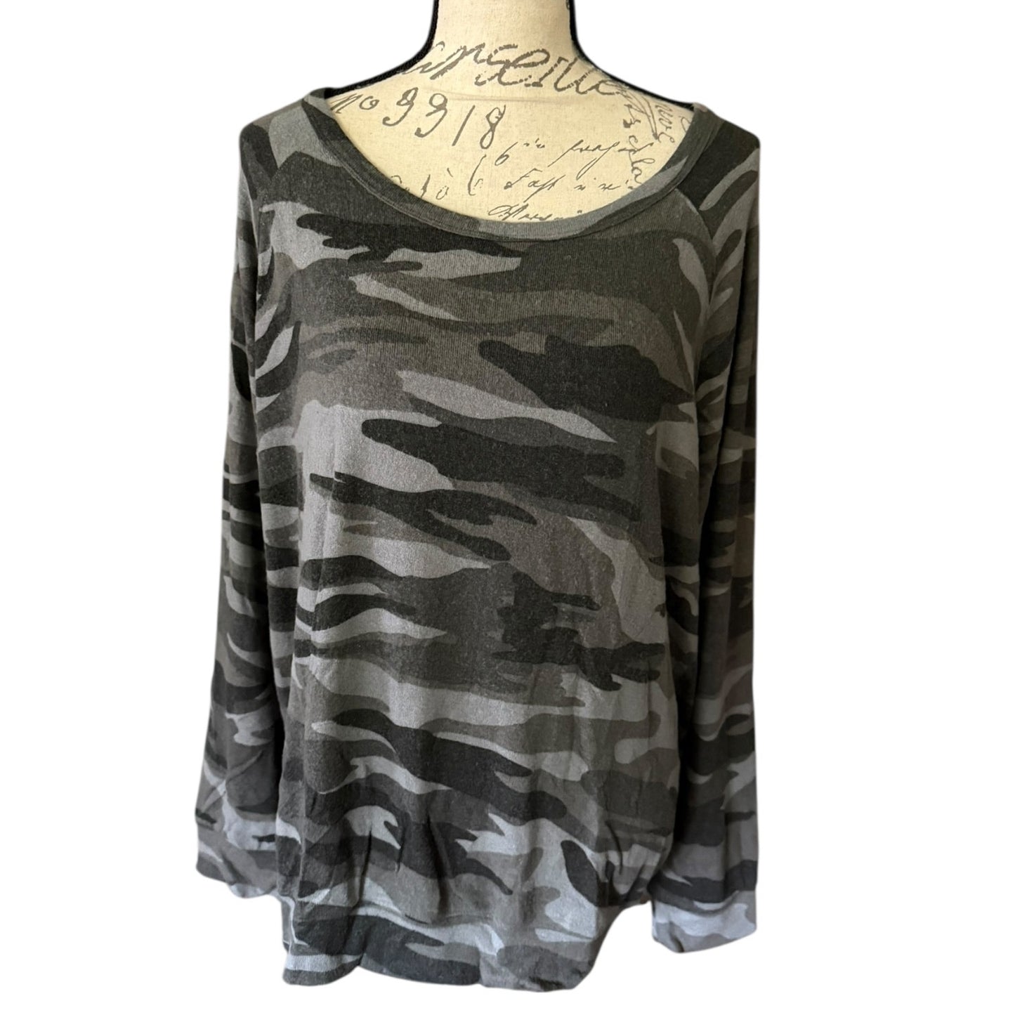 Front of Camouflage-patterned long-sleeve top on a mannequin with a white background