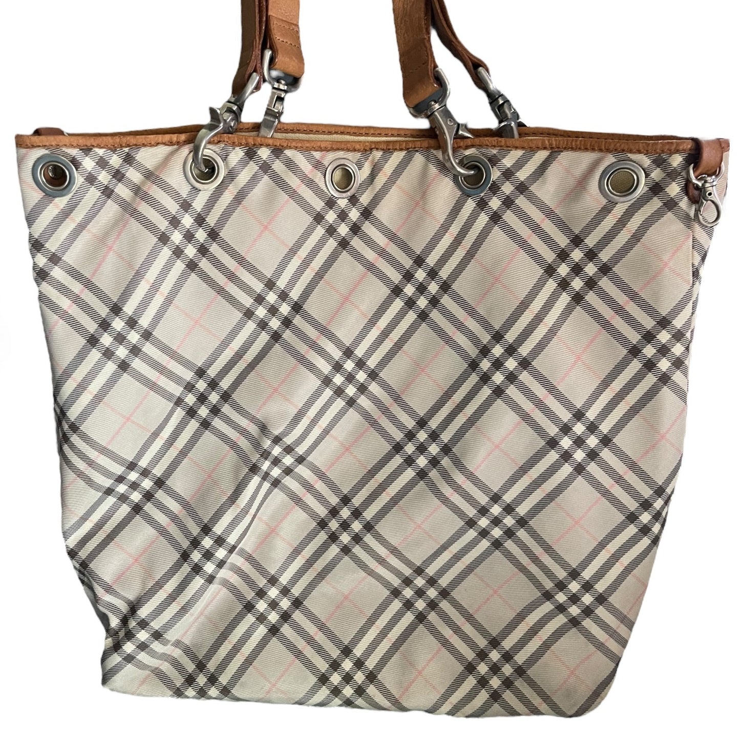 Plaid patterned tote close up of bag with brown handles on a white background