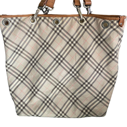 Plaid patterned bag close up with brown leather straps on a white background