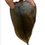 Inteiror of metallic pouch held by a hand on a white background