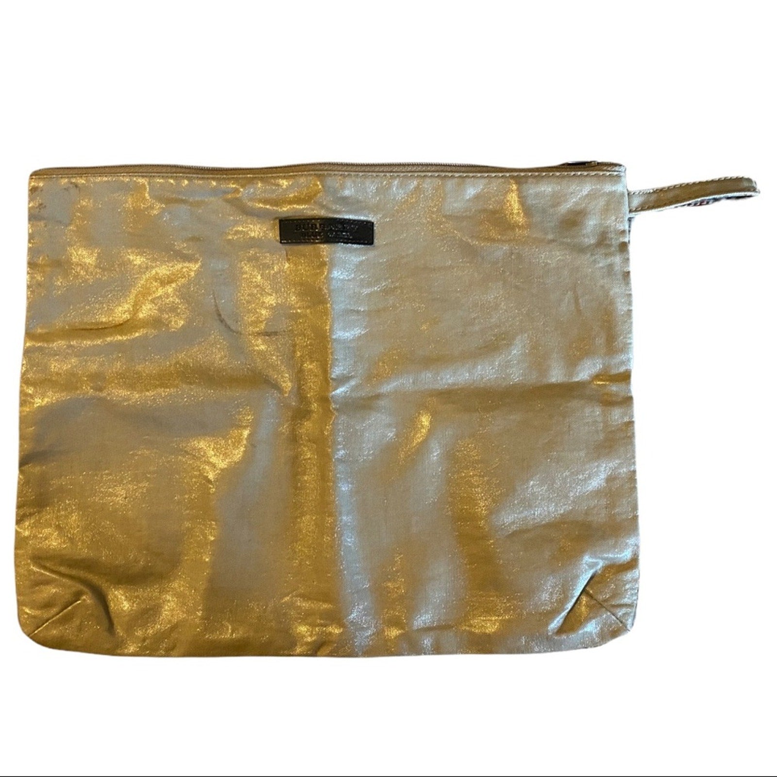 Gold metallic pouch with a visible brand label on a white background