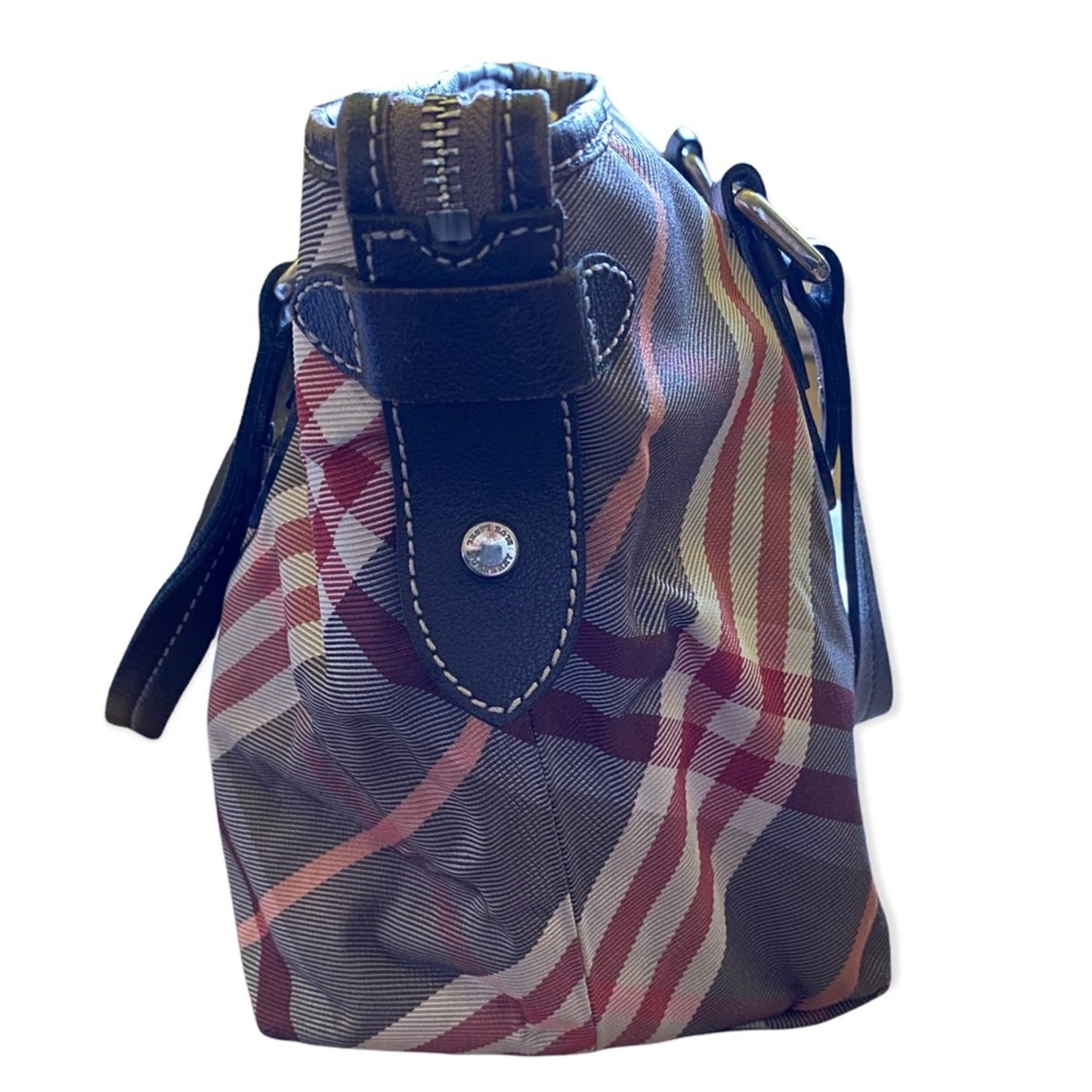 Side of bag with plaid pattern and blue accents on a white background