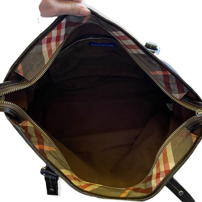 Plaid patterned bag with a zipper, showing the interior.