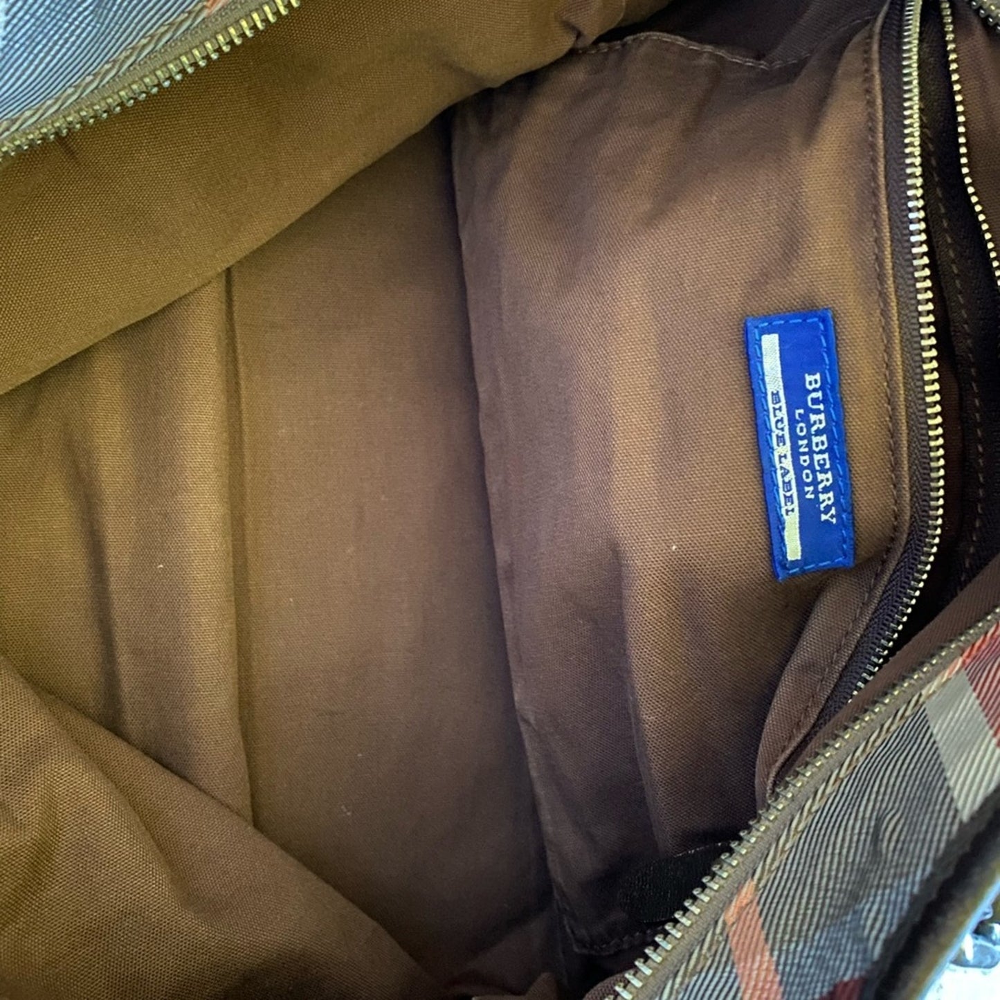 Brown fabric with a blue Burberry label inside a bag.