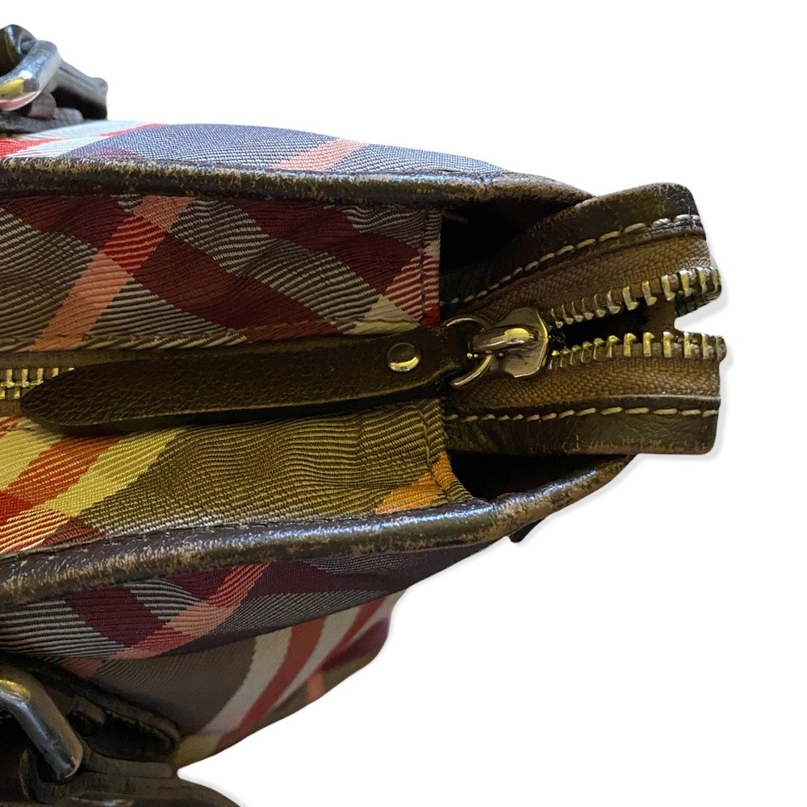 Plaid patterned pouch with a zipper on a white background