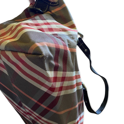 Corner of Plaid bag with a strap on a white background