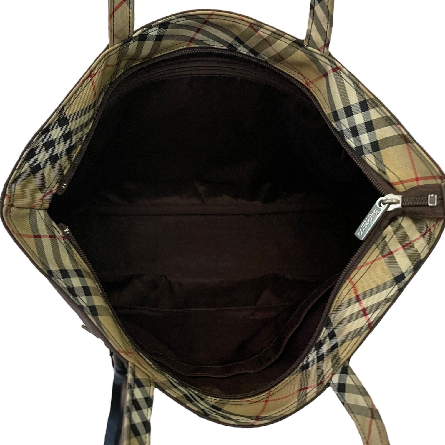 Plaid patterned top of bag with visible brand logo on a white background