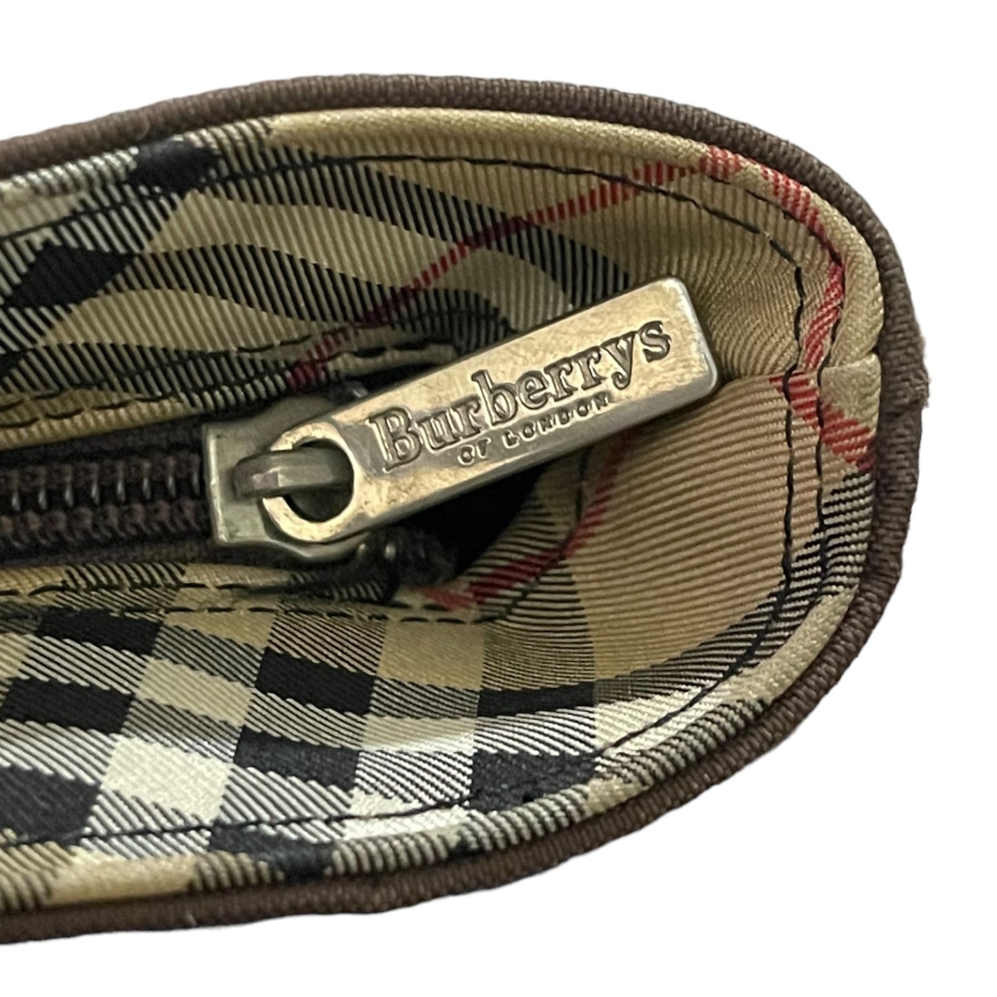 Close-up of a Burberry branded zipper with checkered pattern