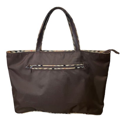 Brown tote bag with checkered patterned interior on a white background