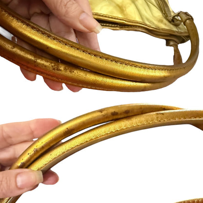 Close up of gold handles on purse and shows issues