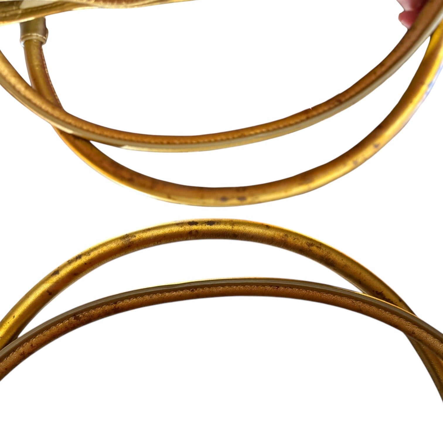 Close up of gold handles from purse with issues