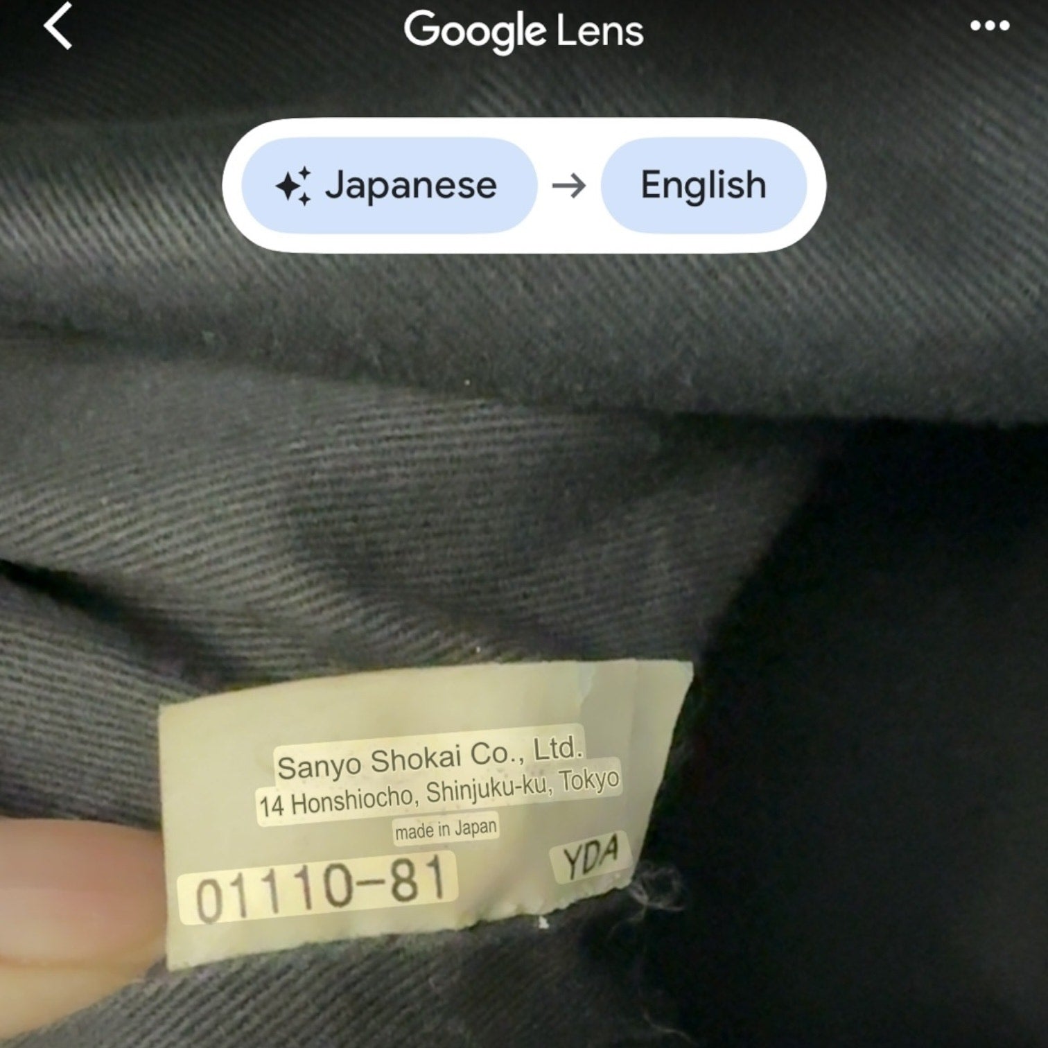 Text label on fabric with Sanyo Shokai Co., Ltd. information, displayed through Google Lens app.